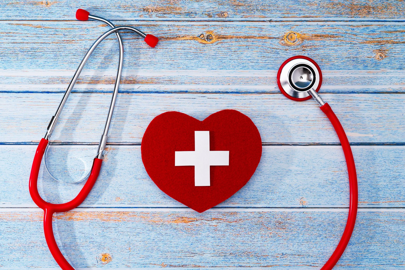 World Red Cross day. Red heart with Stethoscope on wooden table background